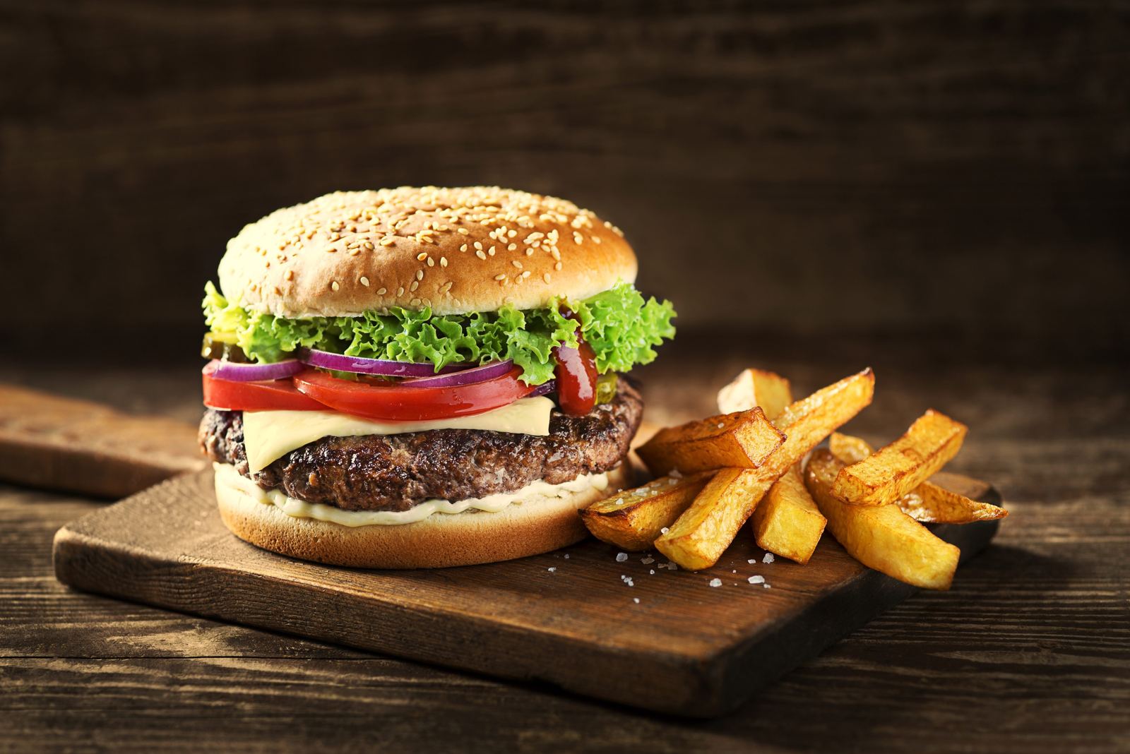 A BiteShack signature burger with caramelized onions and melted cheese
